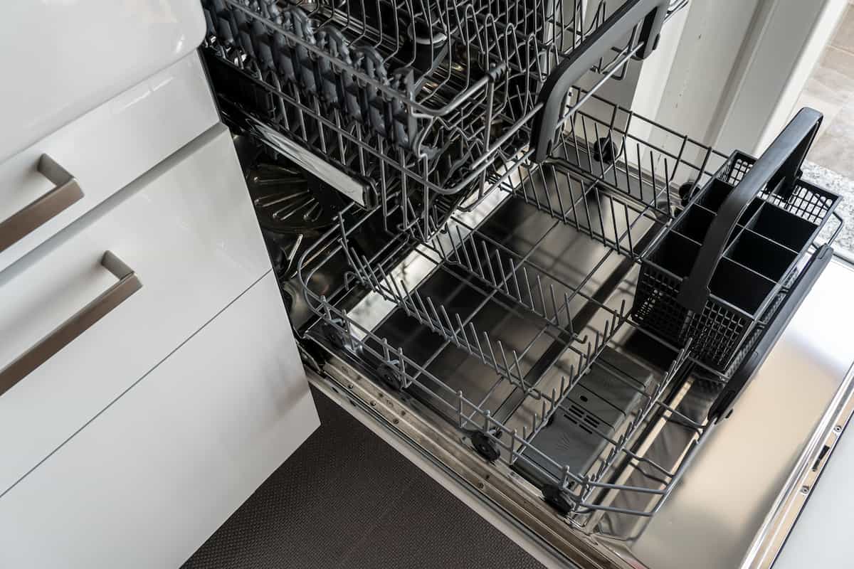 Open dishwasher racks pulled out during a service visit