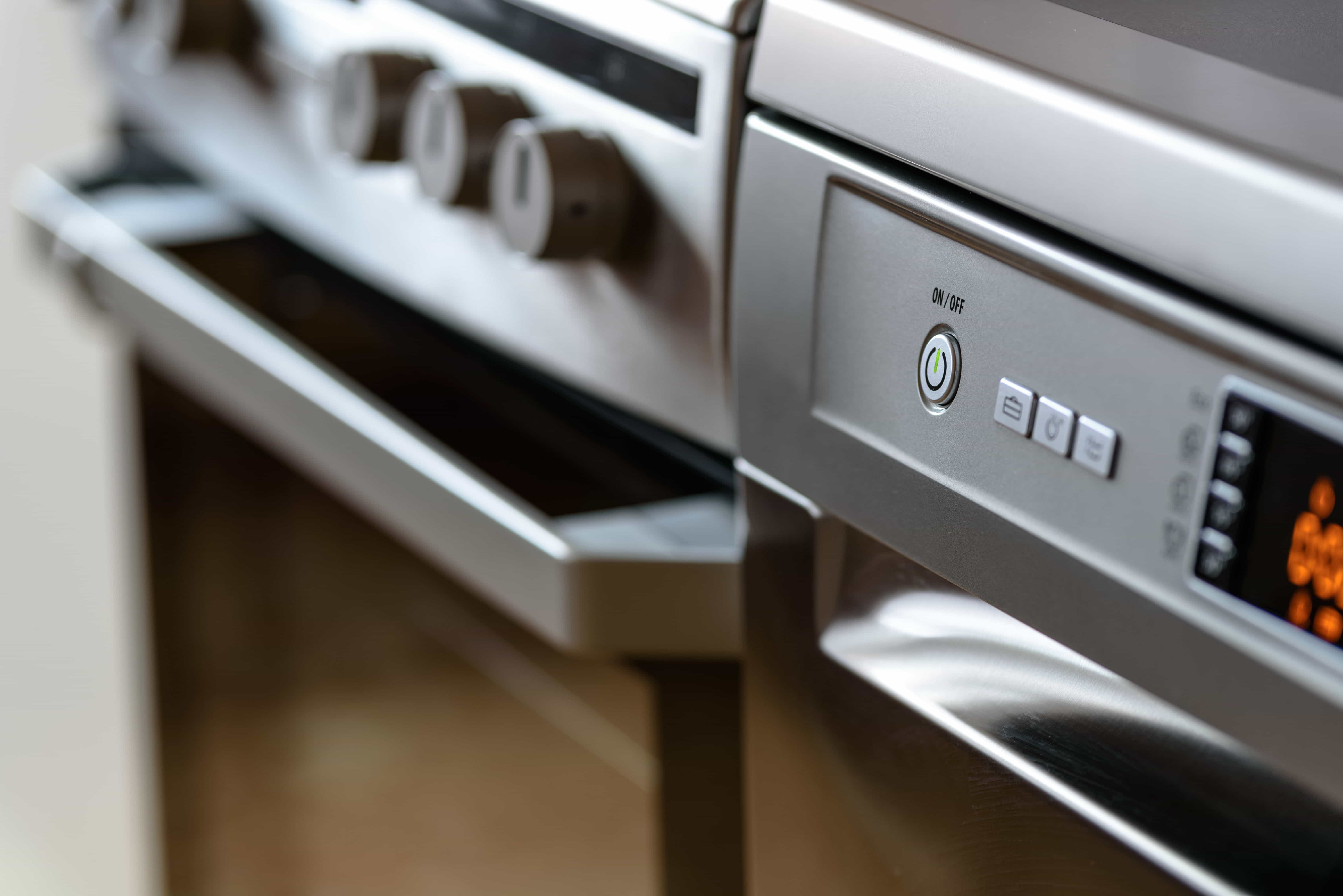 Open oven door with heating element visible during repair